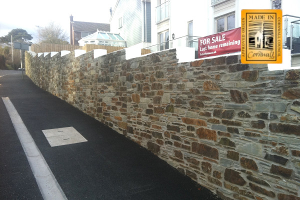 A mixture of rustic cut stone and blue grey cut stone on this wall