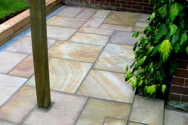 Buff sandstone paving slabs used to create this patio