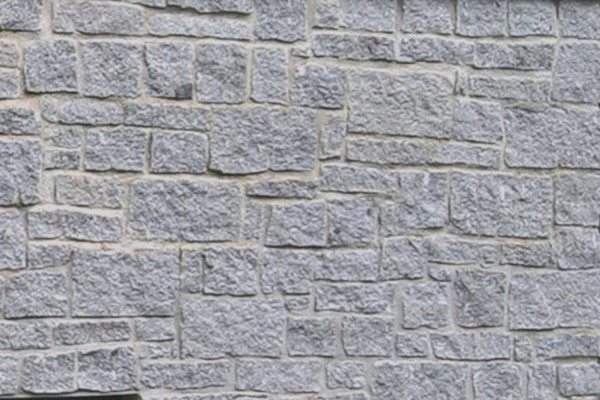 Cropped silver grey granite walling
