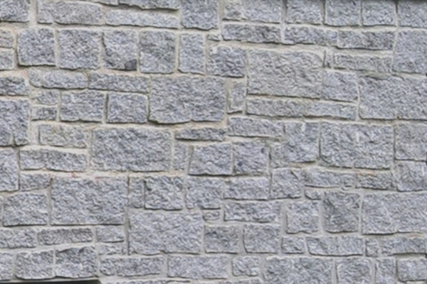 Cropped silver grey granite walling