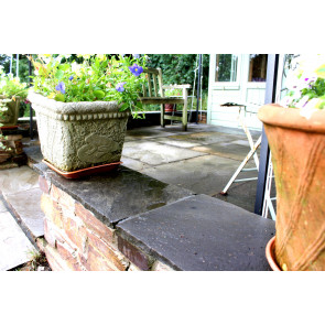 Black sandstone paving slabs used to cap a wall