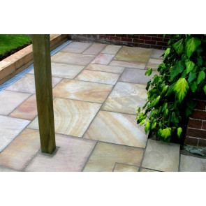 Buff sandstone paving slabs used to create this patio